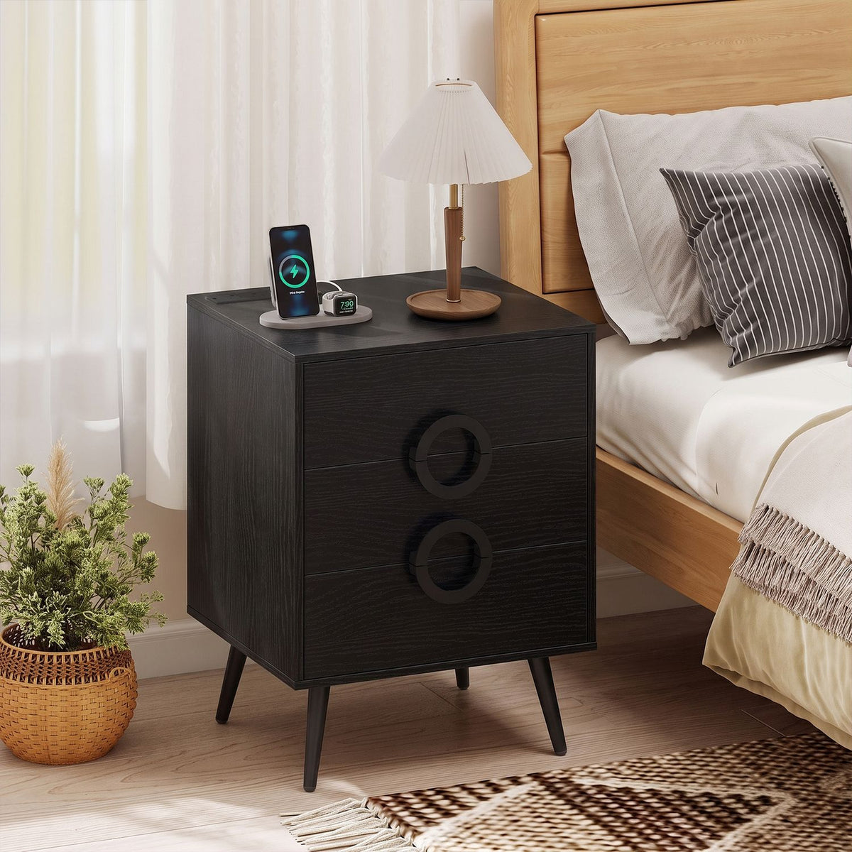 Black modern nightstand with three drawers, power outlets, and cable hole for bedside convenience.