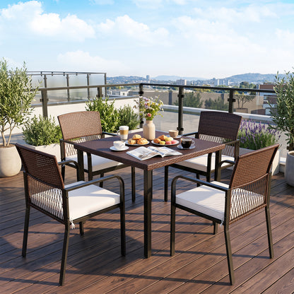 Set of four beige outdoor patio dining chairs with padded cushions and adjustable feet for patio comfort and stability.
