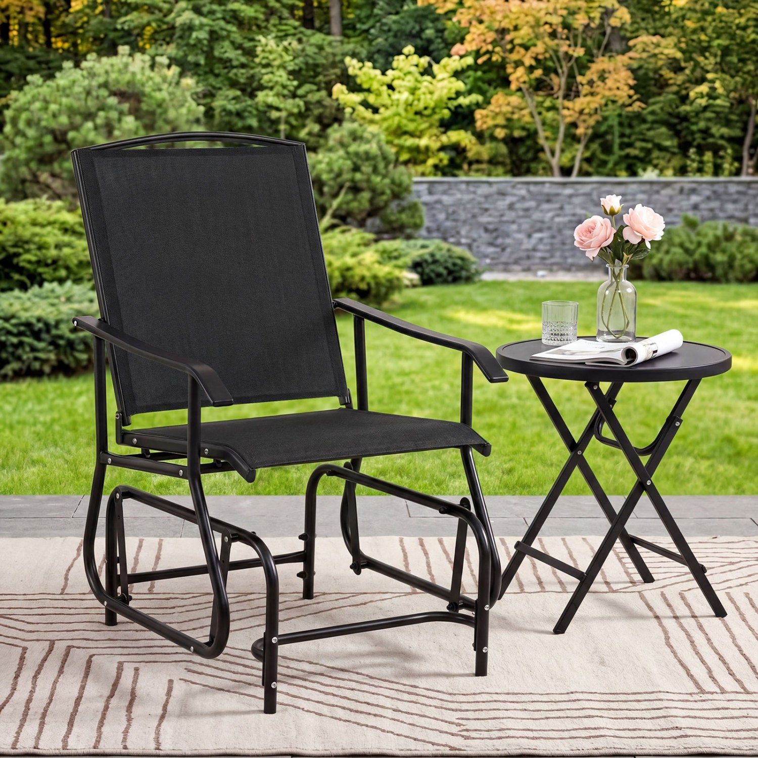 Black outdoor glider chair with metal frame and armrests, ideal for patio seating and outdoor relaxation.