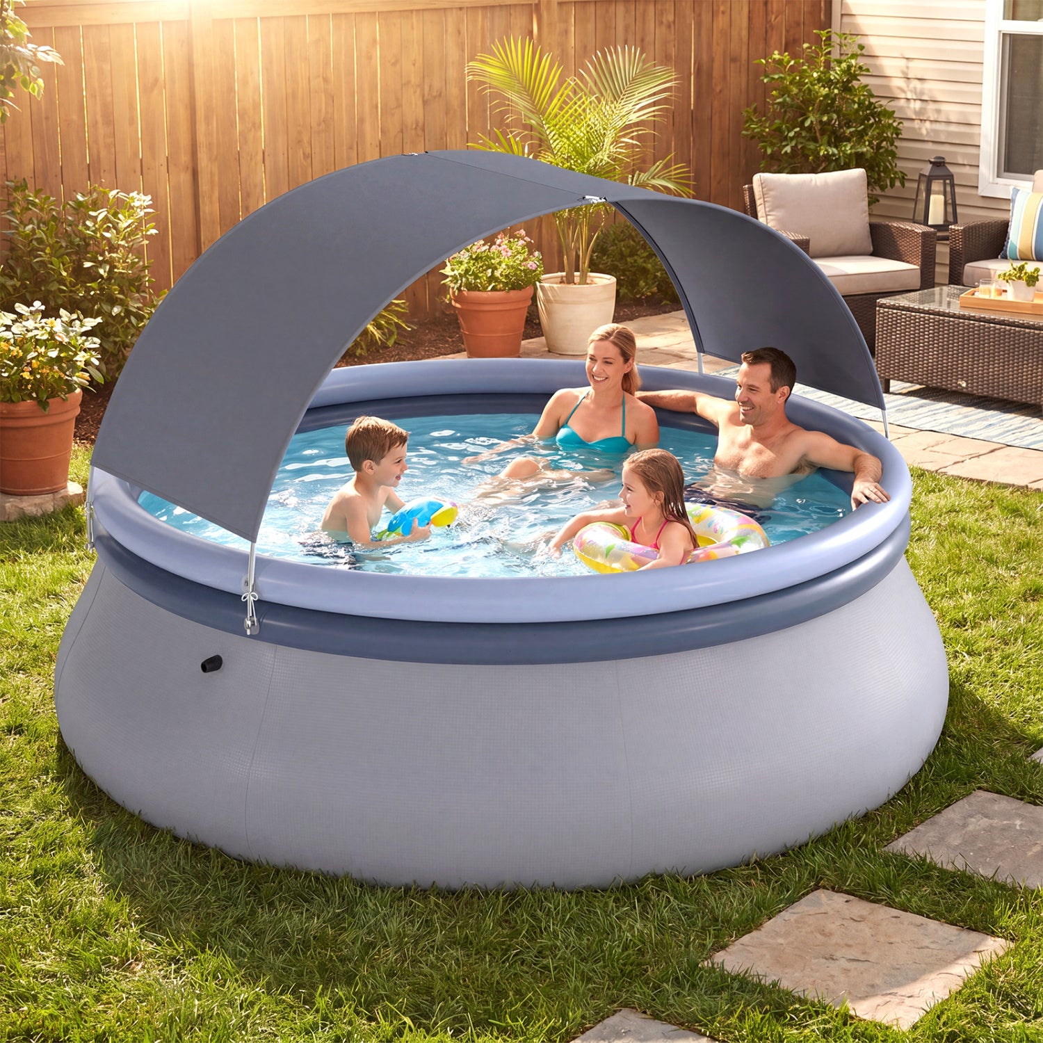 Inflatable outdoor swimming pool with sunshade canopy from Wilsons Home Store, set up outdoors in a backyard.