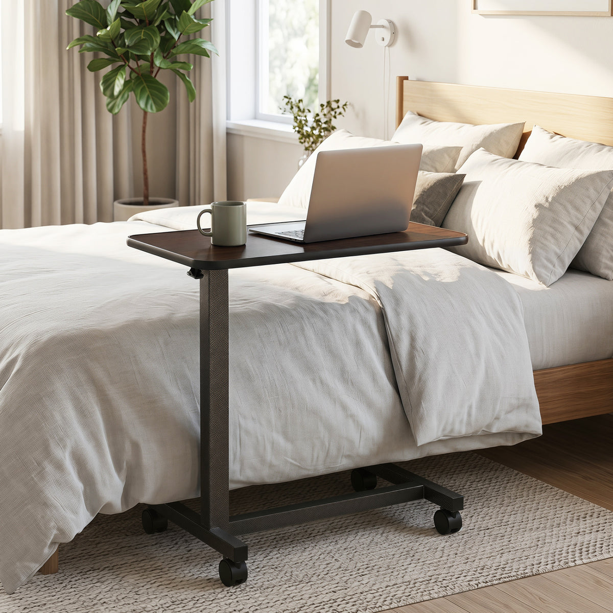 Wooden overbed table with lockable wheels and H-shaped base, ideal for hospital or home use, in walnut finish.