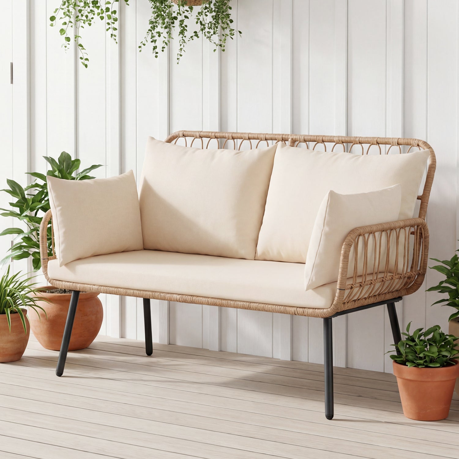 Beige PE rattan outdoor loveseat with two seats and pillows, perfect for patio relaxation and outdoor seating.