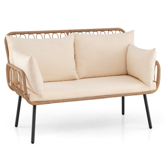 Beige PE rattan outdoor 2-seater patio loveseat with pillows, ideal for outdoor seating and patio furniture setups.