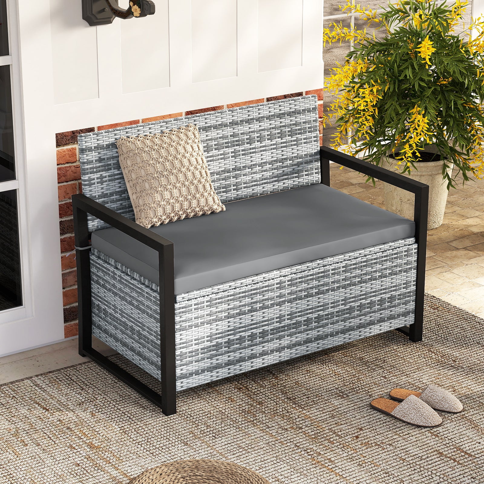 Outdoor wicker patio storage bench with built-in storage and loveseat design, ideal for outdoor garden and patio organization.
