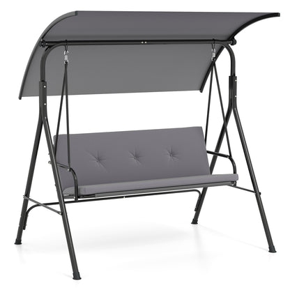 Beige outdoor patio swing chair with adjustable canopy, removable cushion, and metal stand for porch relaxation.
