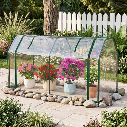Green mini outdoor greenhouse with PE cover and zippered door for vegetables, ideal for garden use.