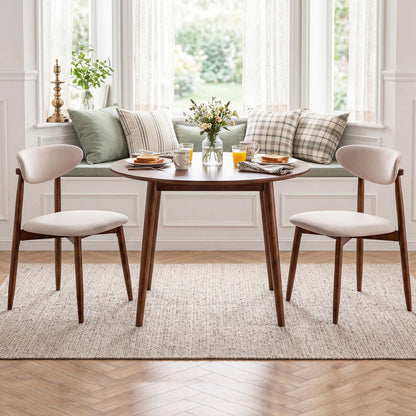 Set of 2 beige fabric upholstered dining chairs with curved backs, modern design, from Wilsons Home Store.