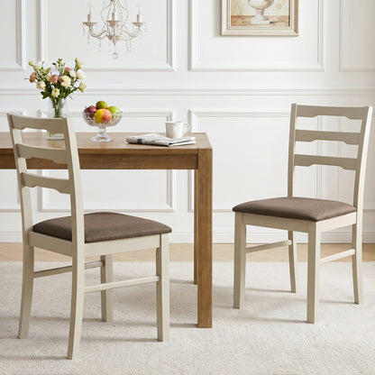 Set of 2 linen-style upholstered dining chairs with wood frames, white fabric, and modern design for kitchen and dining spaces.