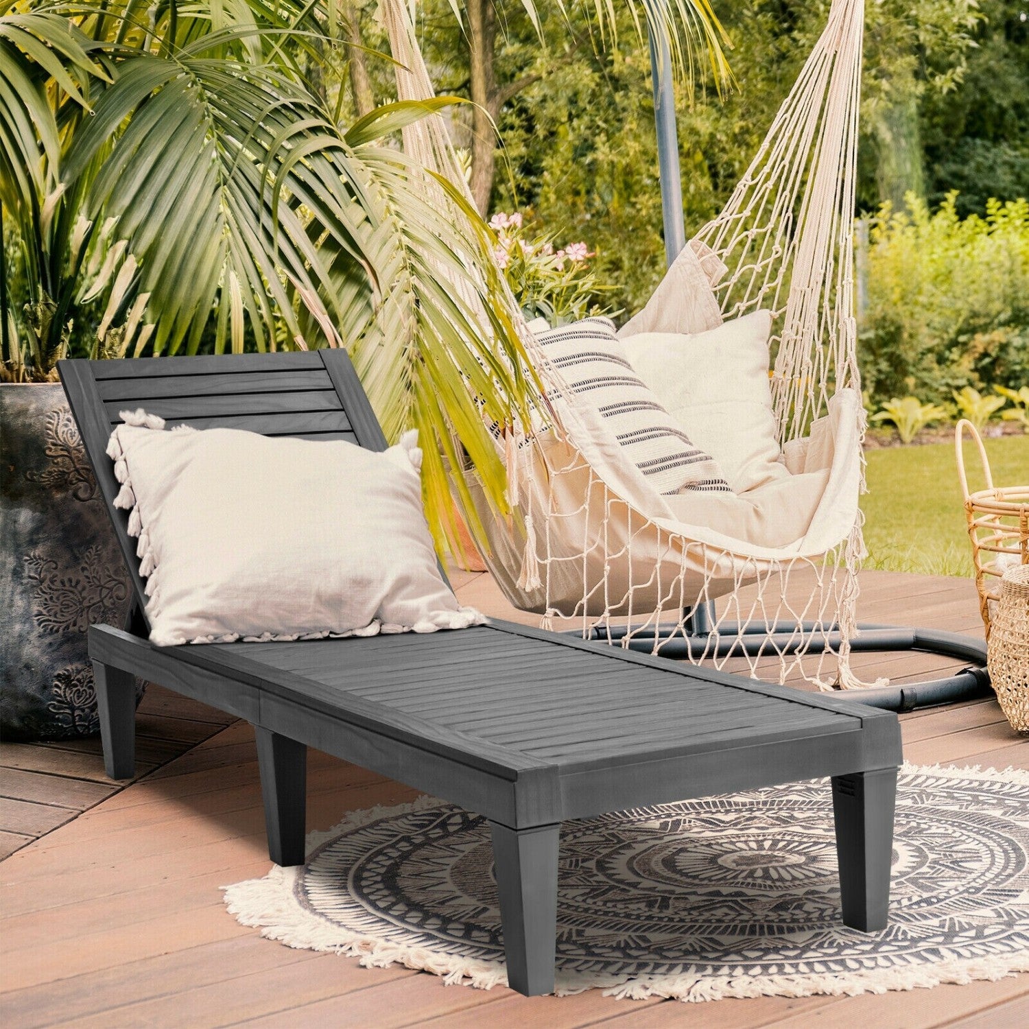 Set of two black outdoor chaise lounge chairs with adjustable backrests, perfect for patio relaxation.