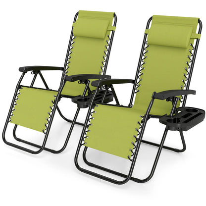 Set of 2 green portable zero gravity outdoor chairs with cup holder trays and adjustable backrests for patio or beach use.