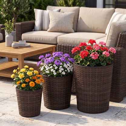 Set of three brown plastic outdoor planters with drainage holes and saucers for porch and garden gardening.