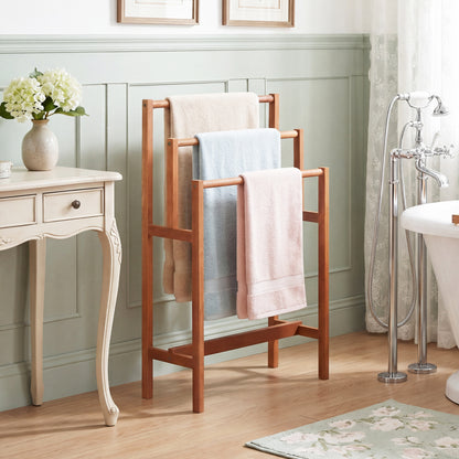 Solid wood 3-tier freestanding towel rack with teak oil finish, ideal for bathroom organization and stylish towel storage.