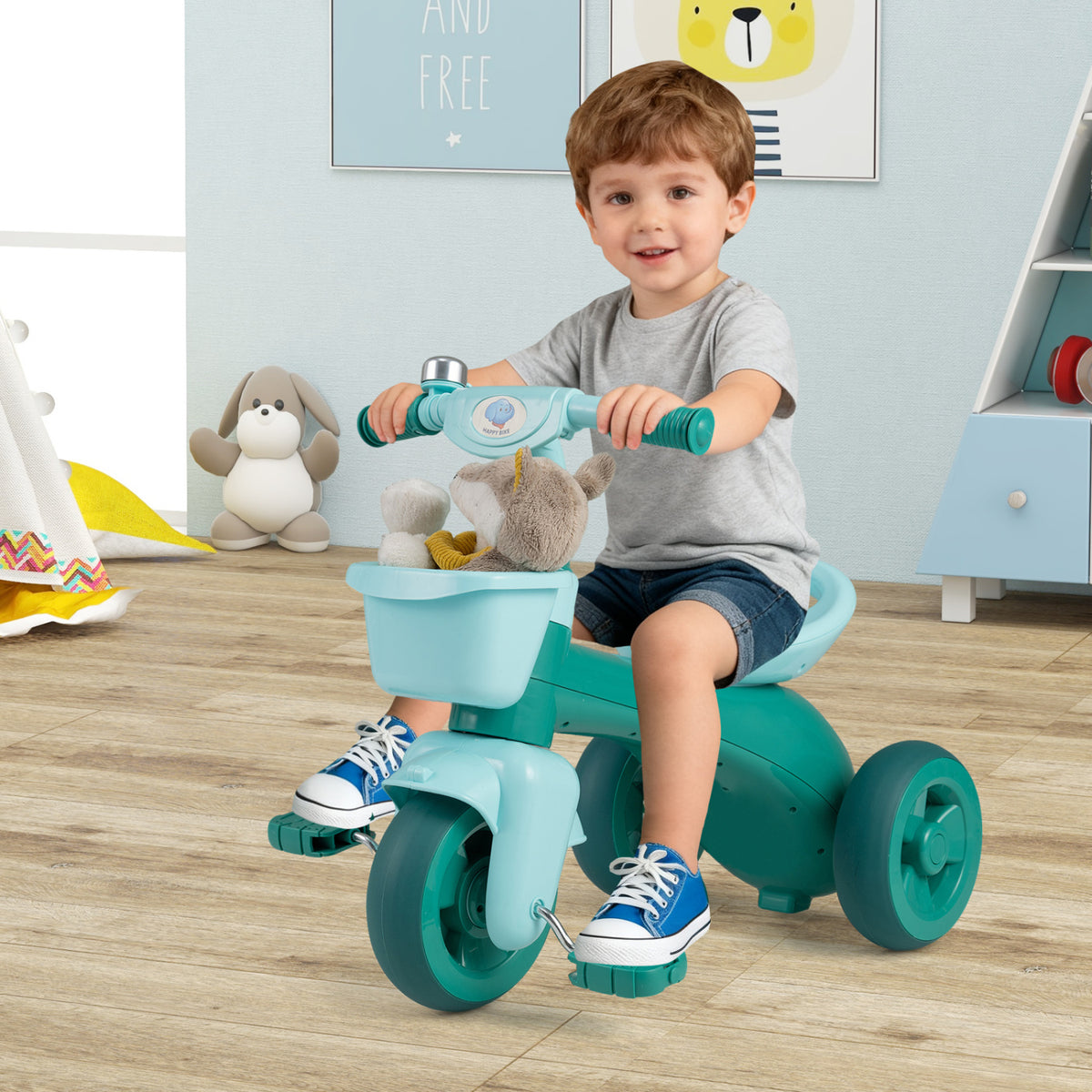 Green toddler tricycle with limited steering, front baskets, and bell, designed for young children, from Wilsons Home Store.