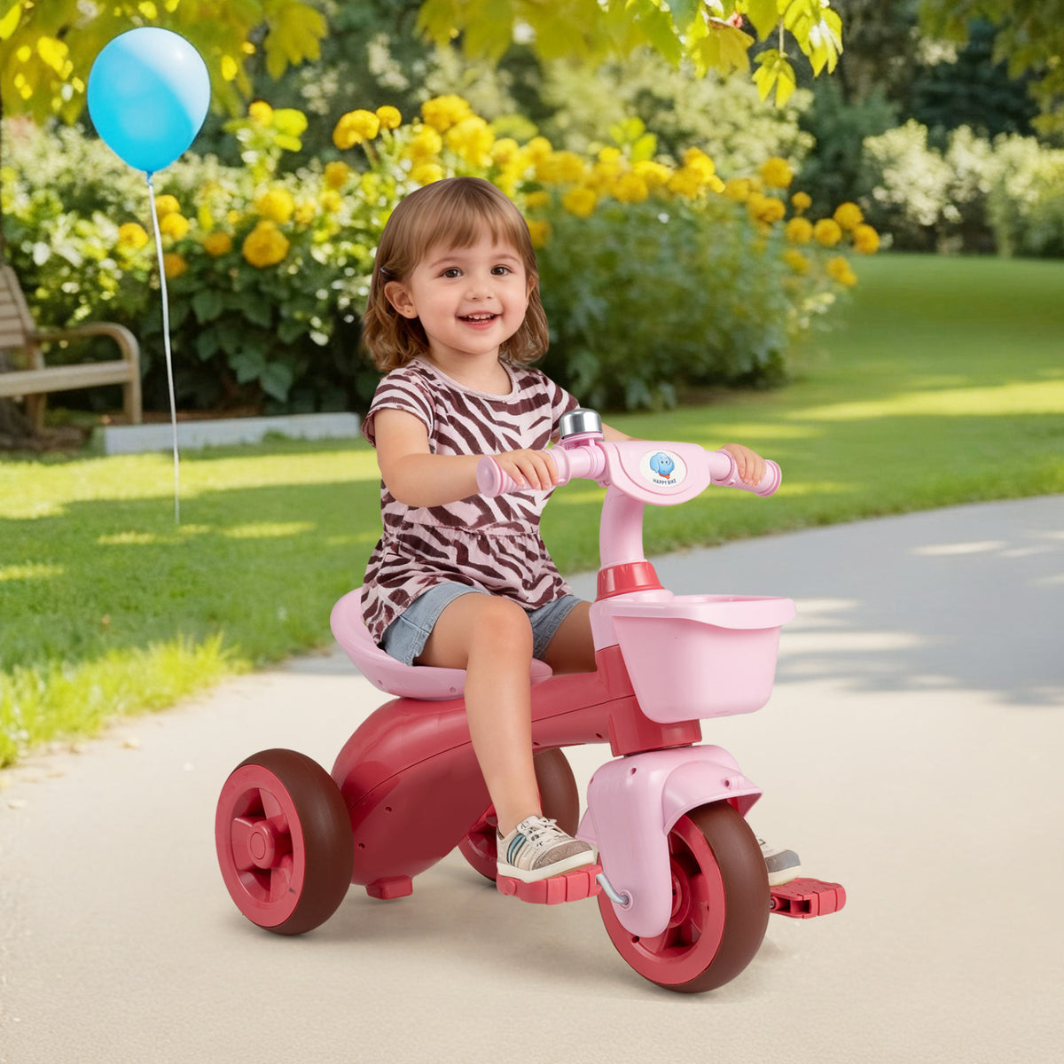 Green toddler tricycle with limited steering, front baskets, and bell, designed for ride-on fun for young children.