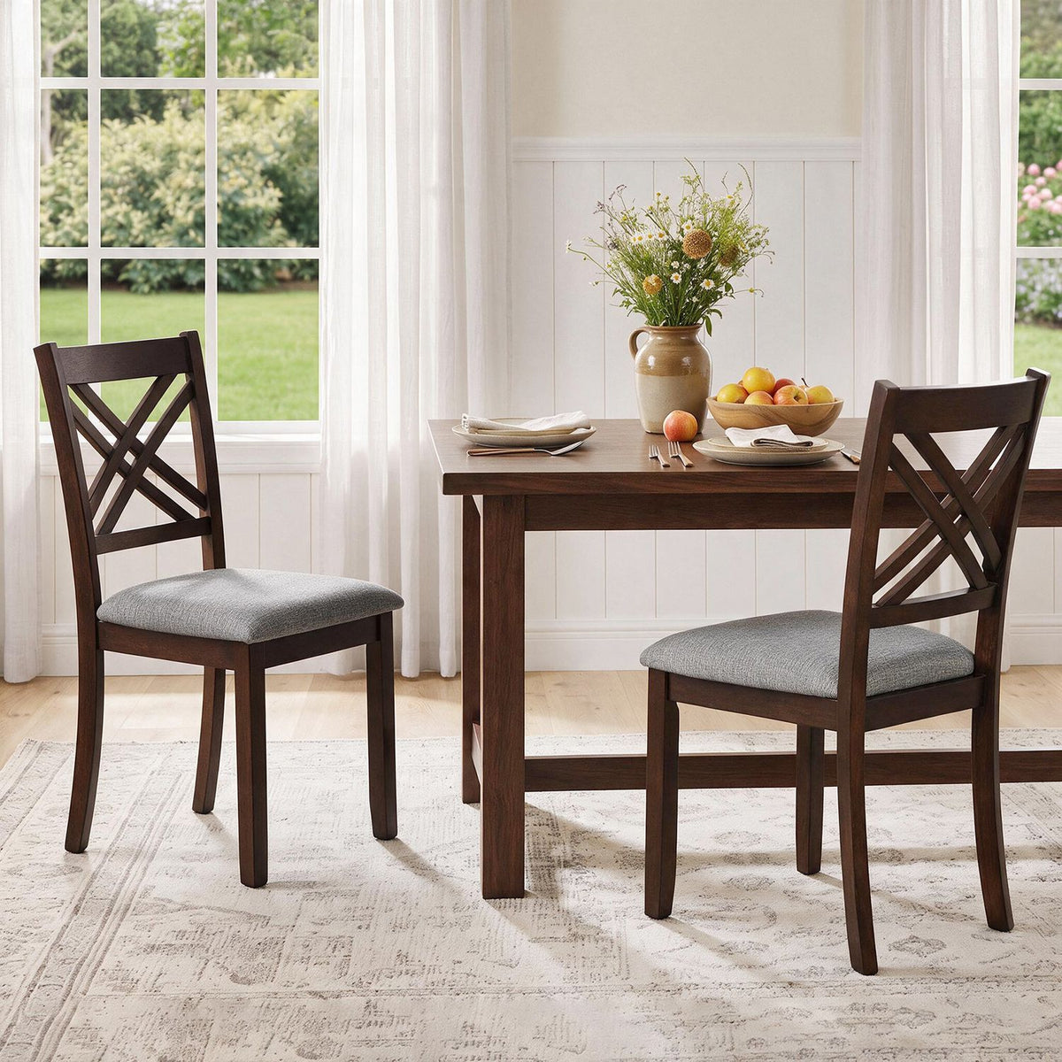 Set of two brown wooden dining chairs with fabric padded seats and solid rubber wood frames for kitchen dining.