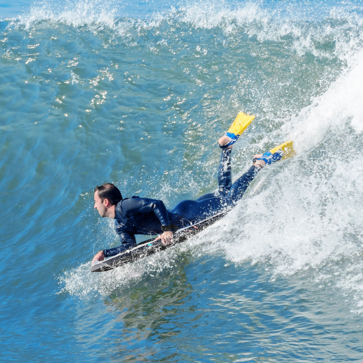 Lightweight multicolor body board with EPS core, XPE deck, and HDPE bottom, ideal for water sports and surfing.