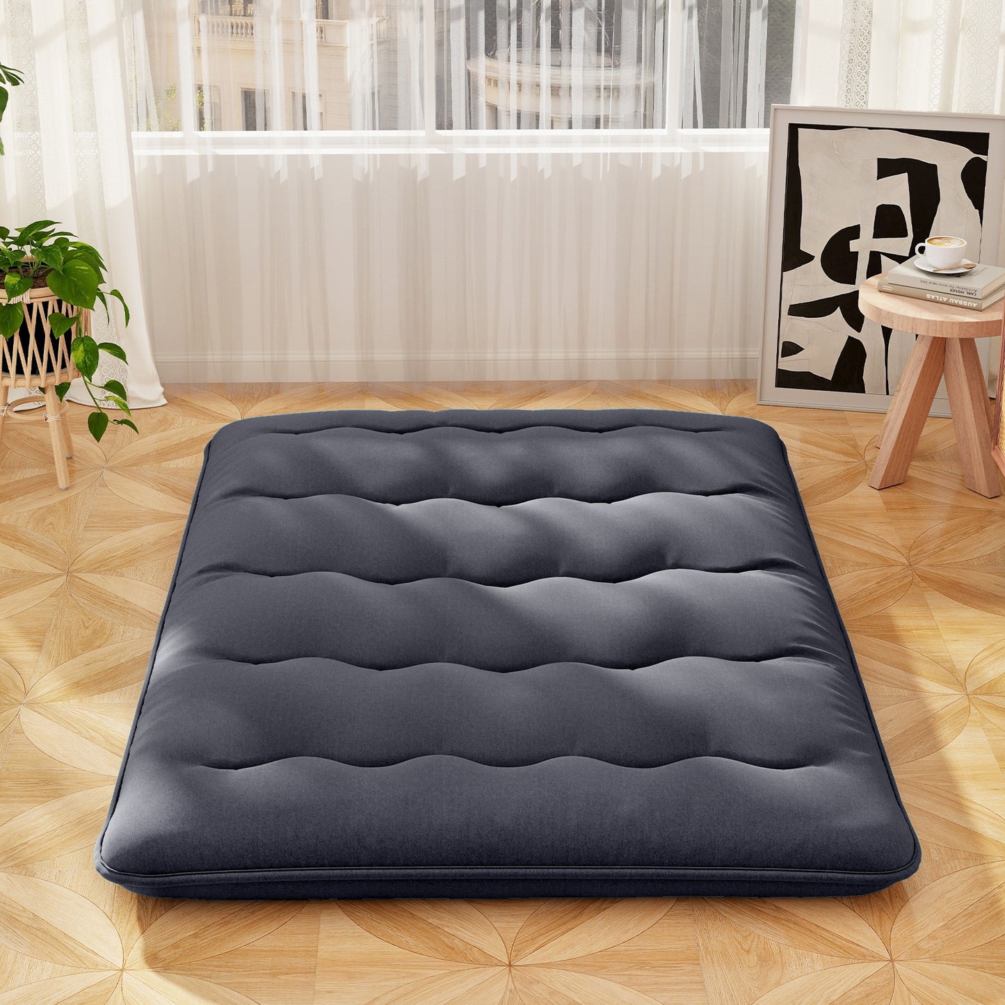 Full-size futon mattress with washable cover and foldable design, shown on a bedroom floor, by Wilsons Home Store.