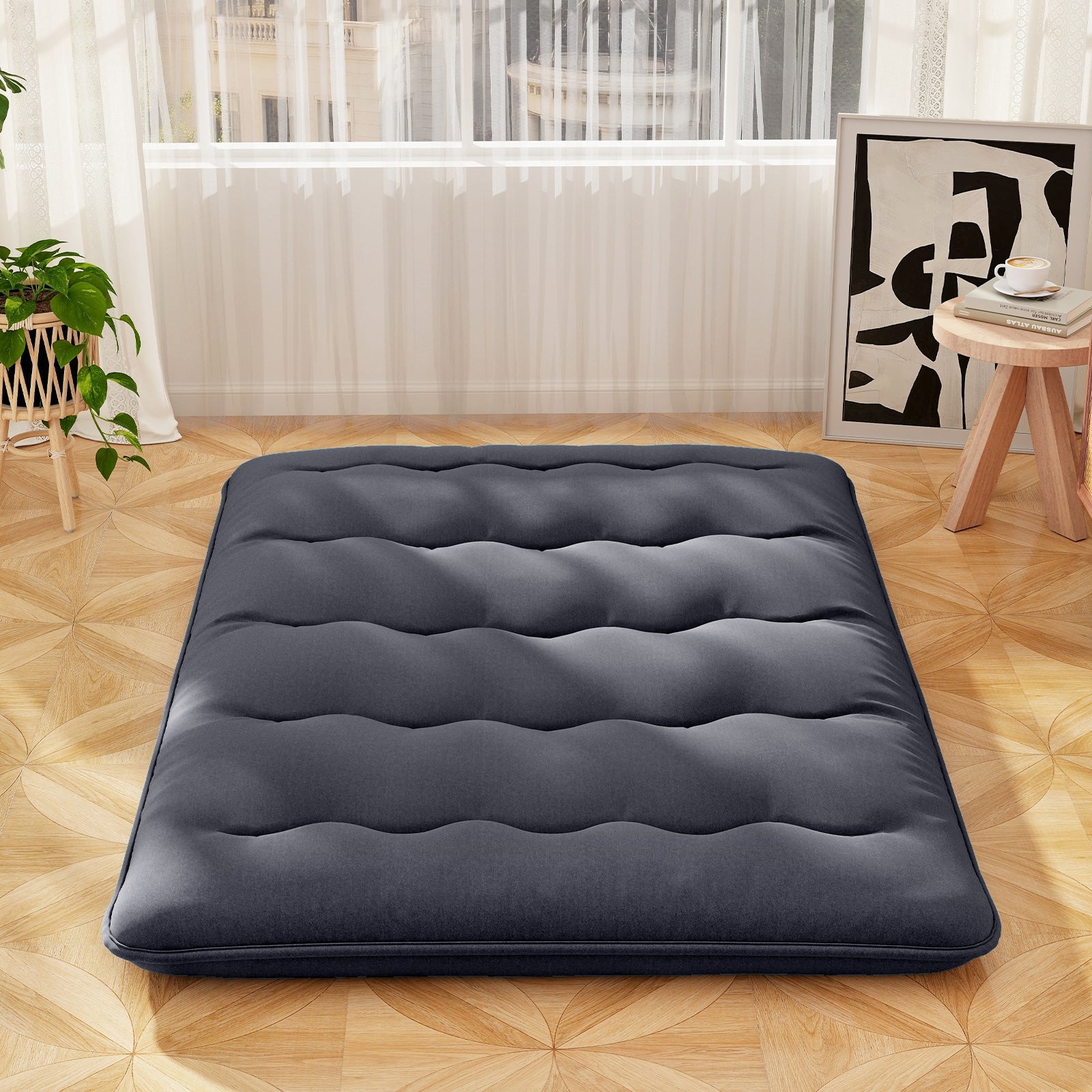 Full-size futon mattress with washable cover and foldable design, shown on a bedroom floor, by Wilsons Home Store.