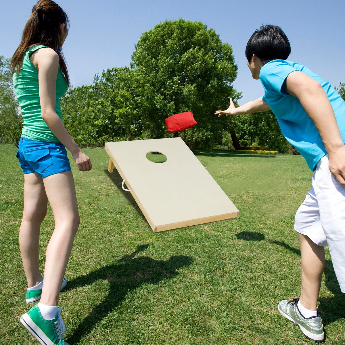 Solid wood cornhole board set with 8 bean bags, portable outdoor game for fun and recreation.