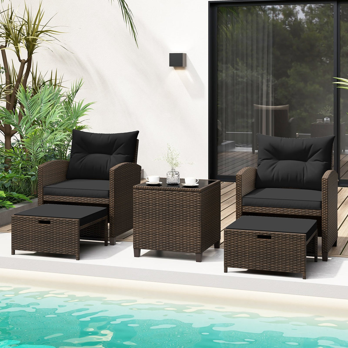 Beige 5-piece outdoor patio rattan furniture set with 2 ottomans and glass coffee table for outdoor living space.