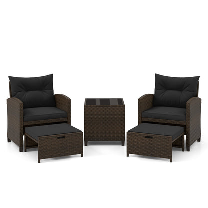 Beige 5-piece patio rattan furniture set with two ottomans and glass coffee table for outdoor patio relaxation.